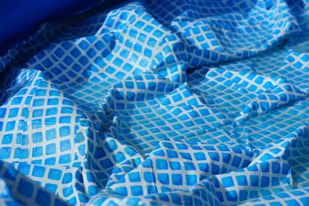 Bright blue patterned pool liner with a geometric design enhances the aesthetic of custom swimming pools. Perfect for creating a vibrant, inviting pool environment.