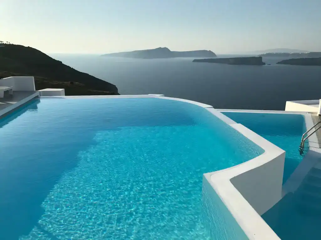 Breathtaking infinity pool overlooking the Aegean Sea with a stunning island view, showcasing luxurious pool design and scenic waterfront setting.