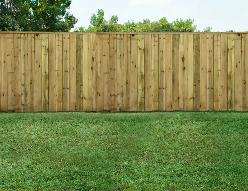 A wooden privacy fence installed on a lush green lawn, providing a secure and private outdoor space for homeowners. Durable and natural-looking fencing for backyard privacy and aesthetic appeal.