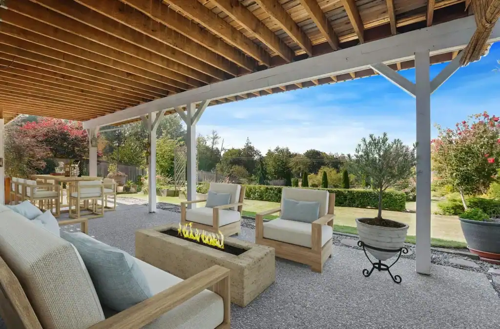 Beautiful outdoor covered patio with cozy seating, a modern fire feature, and lush landscaping, perfect for relaxing and entertaining in your custom-designed Dream Pool area.