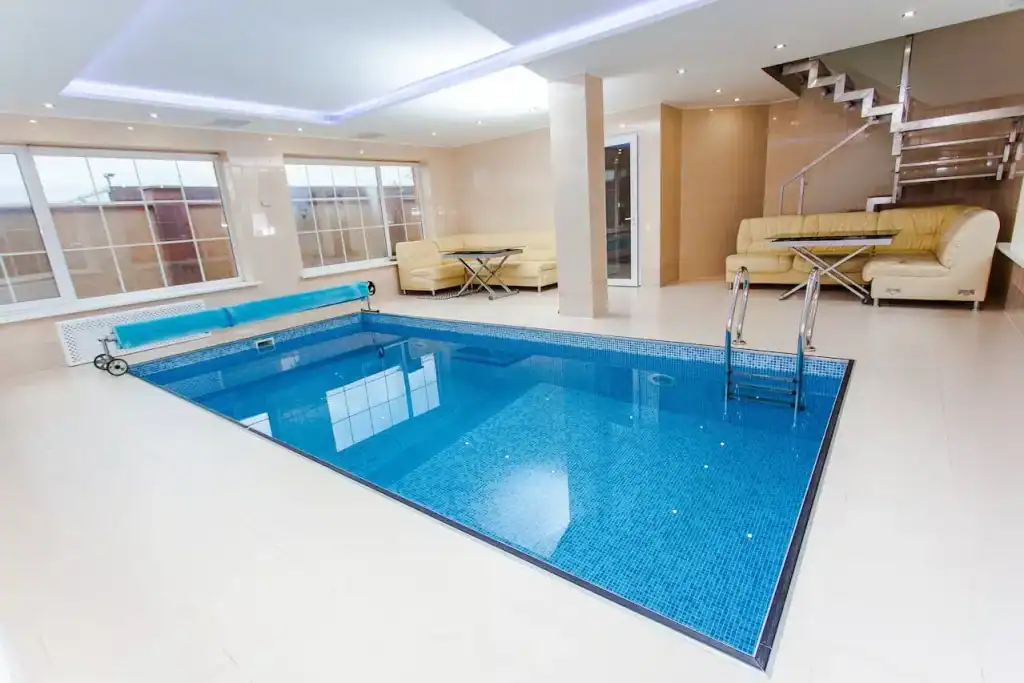 Luxurious indoor private swimming pool with blue tiles and modern design, perfect for home relaxation and leisure.