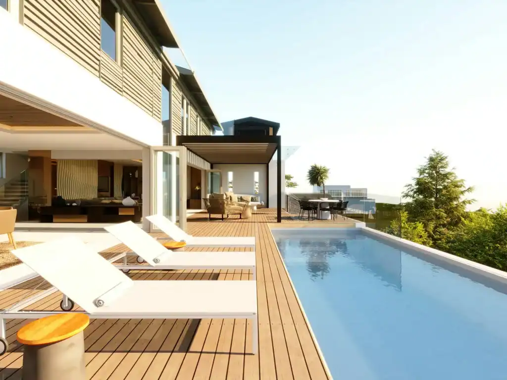 Ultra-modern backyard with a sleek rectangular pool, sun loungers, and a stylish outdoor patio area overlooking lush greenery, perfect for luxury outdoor living and relaxation.