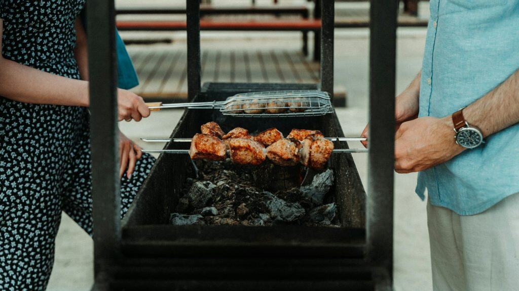 Juicy grilled chicken skewers cooking over a charcoal grill during outdoor barbecue.