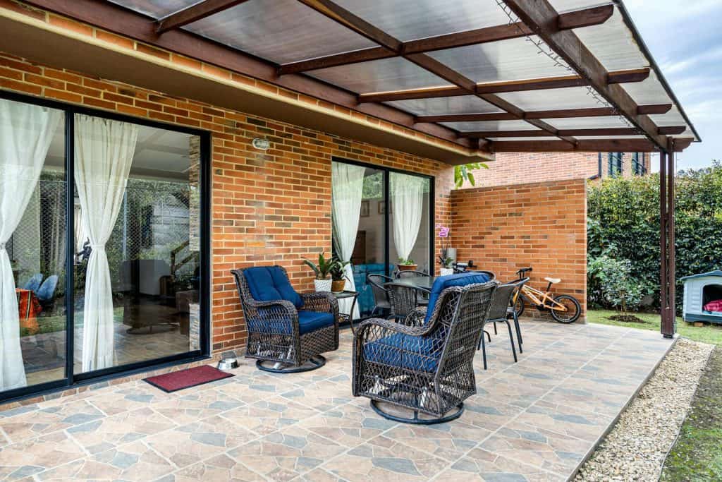 Outdoor patio with seating area and shaded cover.